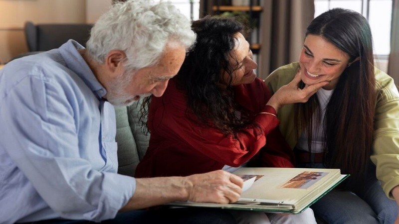 cheerful people looking at old photos